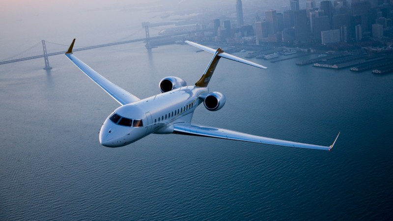 Global Express in flight over city